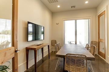 Midlothian apartment for rent - A room with a long table and chairs and a television on the wall.