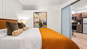 Seattle apartment for rent - A bedroom with a large bed and a painting on the wall.