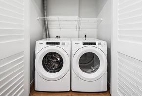 Seattle apartment for rent - Two white Whirlpool washing machines in a small laundry room.