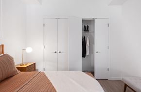 Hyattsville apartment for rent - A bedroom with a bed, nightstand, and wardrobe.