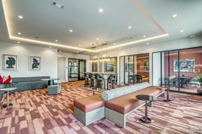 Lewisville apartment for rent - A modern lounge area with a bench and a table.