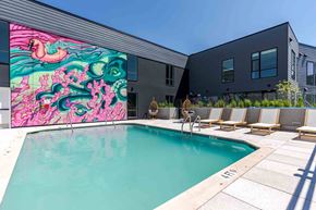 Hyattsville apartment for rent - A pool with a mural on the side of a building.