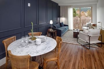 Portland apartment for rent - A living room with a round marble table surrounded by chairs.