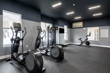 24/7 Modern fitness center with cardio and free weights