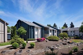 Vancouver apartment for rent - a group of houses in a row with a rock garden in front of them