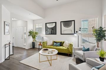 Pflugerville apartment for rent - A living room with a green couch and a coffee table.
