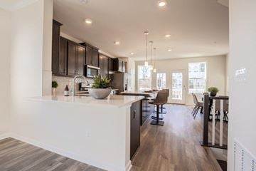 Suitland apartment for rent - an open kitchen and living room with a table and chairs
