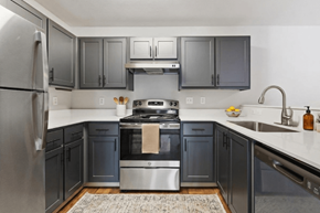 Beaverton apartment for rent - A modern kitchen with dark grey cabinets and stainless steel appliances.