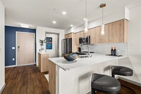 Kirkland apartment for rent - Vela Apartments Kitchen with light cabinets and white coutners