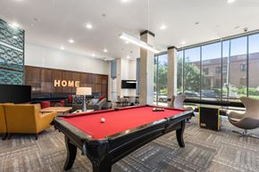 Denver apartment for rent - A pool table in a room with a sign that says "HOME".