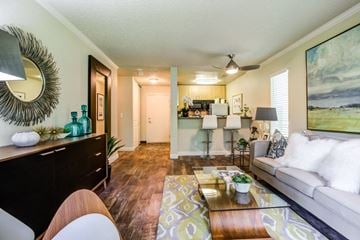 Kirkland apartment for rent - A living room with a couch, coffee table, and a painting on the wall.
