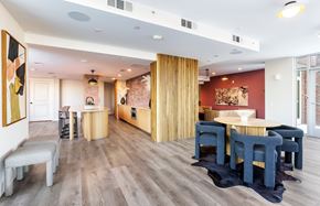 Dallas apartment for rent - A modern dining room with a wooden floor and a large table surrounded by chairs.