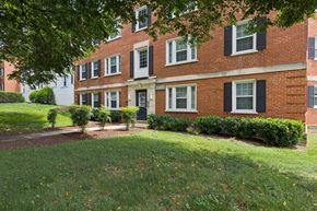 Silver Spring apartment for rent - A red brick building with white trim and black shutters.