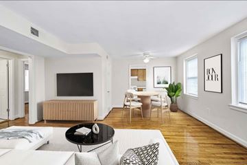 Silver Spring apartment for rent - A living room with a white couch and a television.