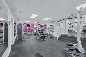 Silver Spring apartment for rent - A gym with a variety of equipment including treadmills, weights, and exercise machines.