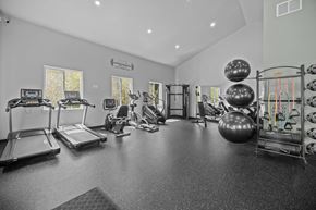 Newport apartment for rent - A spacious gym with treadmills, exercise balls, and other equipment.