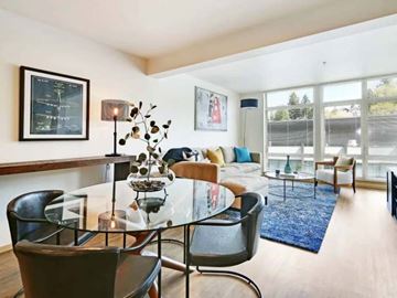 Seattle apartment for rent - A modern living room with a glass table and chairs.
