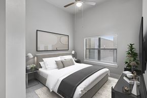 Midland apartment for rent - A modern bedroom with a large bed and a flat-screen TV.