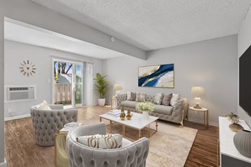 Concord apartment for rent - A living room with a grey couch, a white coffee table, and a painting on the wall.