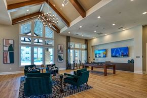 Surprise apartment for rent - a game room with a pool table and a large window