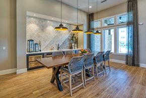 Surprise apartment for rent - a large dining room with a wooden table and chairs