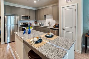 Surprise apartment for rent - a kitchen with stainless steel appliances and granite counter tops