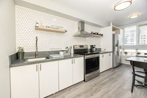 Oakland apartment for rent - a kitchen with white cabinets and stainless steel appliances