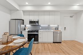 San Diego apartment for rent - OnyxOnPark_SanDiego_CA_Model_1BR__A modern kitchen with a dining table set for two.