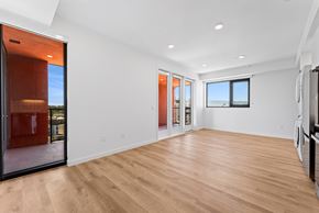San Diego apartment for rent - OnyxOnPark_SanDiego_CA_Vacant_2BR_B1_A spacious room with wooden flooring and a large window.