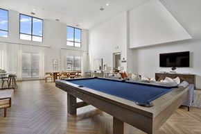 American Fork apartment for rent - Alvera at the Meadows  A pool table is in the middle of a room with a lot of windows.