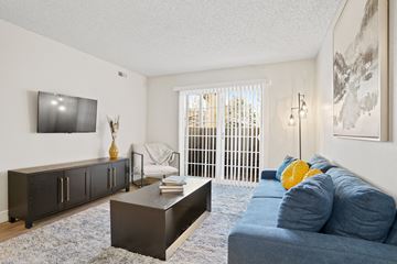 Salt Lake City apartment for rent - a living room with a blue couch and a tv