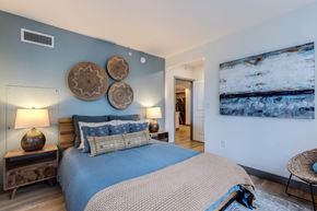 Seattle apartment for rent - a bedroom with a bed and a painting on the wall