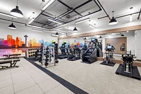 Seattle apartment for rent - A gym with a variety of equipment including treadmills, weights, and exercise machines.