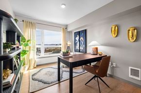 Seattle apartment for rent - A dining room with a table and chairs and a view of the water.