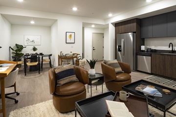 Coeur D Alene apartment for rent - a living room and kitchen with a table and chairs