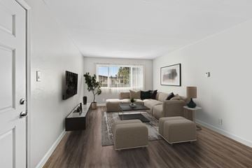 Hayward apartment for rent - A living room with a brown couch and a white door.