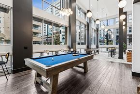 Denver apartment for rent - A pool table in a room with a view of the city.