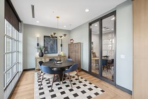 Denver apartment for rent - A black and white checkered rug is on the floor of a room with a dining table and chairs.