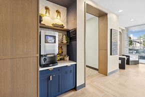 Denver apartment for rent - A modern kitchen with a wooden counter and blue cabinets.