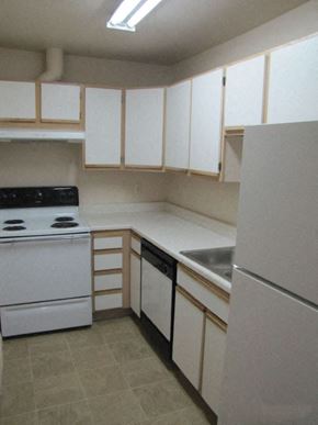 Park City apartment for rent - an empty kitchen with white appliances and white cabinets