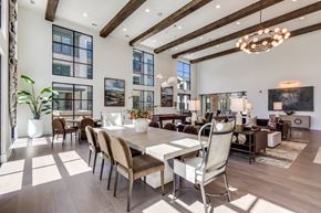 Mckinney apartment for rent - A modern dining room with a large table and chairs.