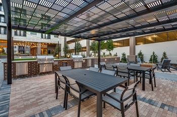 Outdoor pool lounge with outdoor gas grills, and fire pit