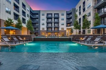 Retreat-style pool with in-water tanning ledge, plunge pool, and expansive deck