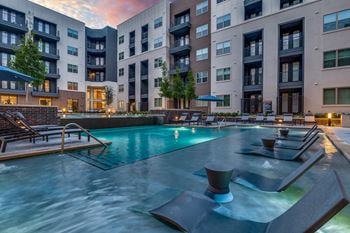 Retreat-style pool with in-water tanning ledge, plunge pool, and expansive deck