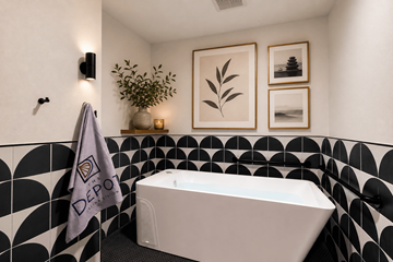 Celina apartment for rent - A bathroom with a black and white tiled wall and a white bathtub.