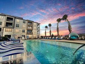 Kyle apartment for rent - Cromwell at Plum Creek Apartments Pool Area and Lounge Chairs