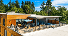 Bainbridge apartment for rent - A modern house with a wooden exterior and a spacious deck.