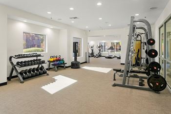 Upgraded expansive fitness center with free weights and cardio equipment