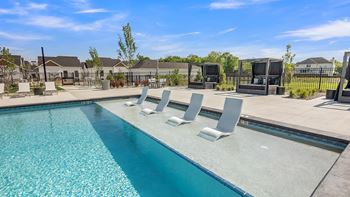 Sparkling resort style pool with lounge seating & private cabanas