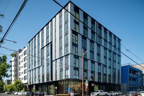 Portland apartment for rent - A modern building with a glass facade is shown.
